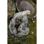 A MODERN COMPOSITE GARDEN WATER FEATURE in the form of a rockpool with two otters seated height