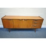 A MID CENTURY TEAK SIDEBOARD, with three cupboard doors and three drawers, on square tapering