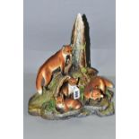 A BOEHM SCULPTURE OF A FAMILY OF FOXES, in a naturalistic woodland setting, limited edition, from