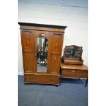 AN EDWARDIAN MAHOGANY AND INLAID WARDROBE, with an overhanging cornice, a single mirrored door,