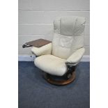 A CREAM STRESSLESS RECLINING ARMCHAIR, with an adjustable tray, width 75cm x depth 70cm x height