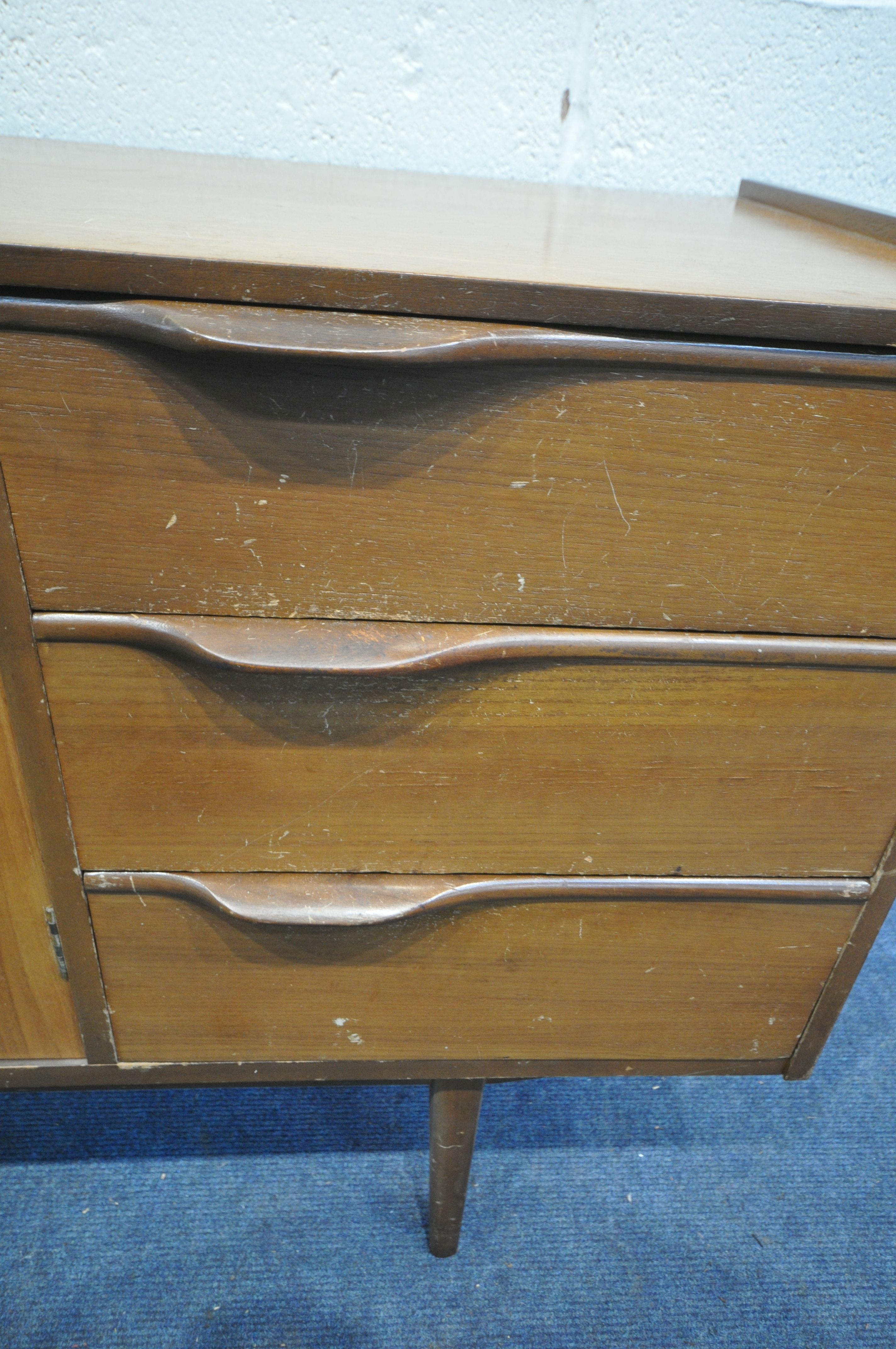 A MID CENTURY TEAK SIDEBOARD, with three cupboard doors and three drawers, on square tapering - Image 4 of 6