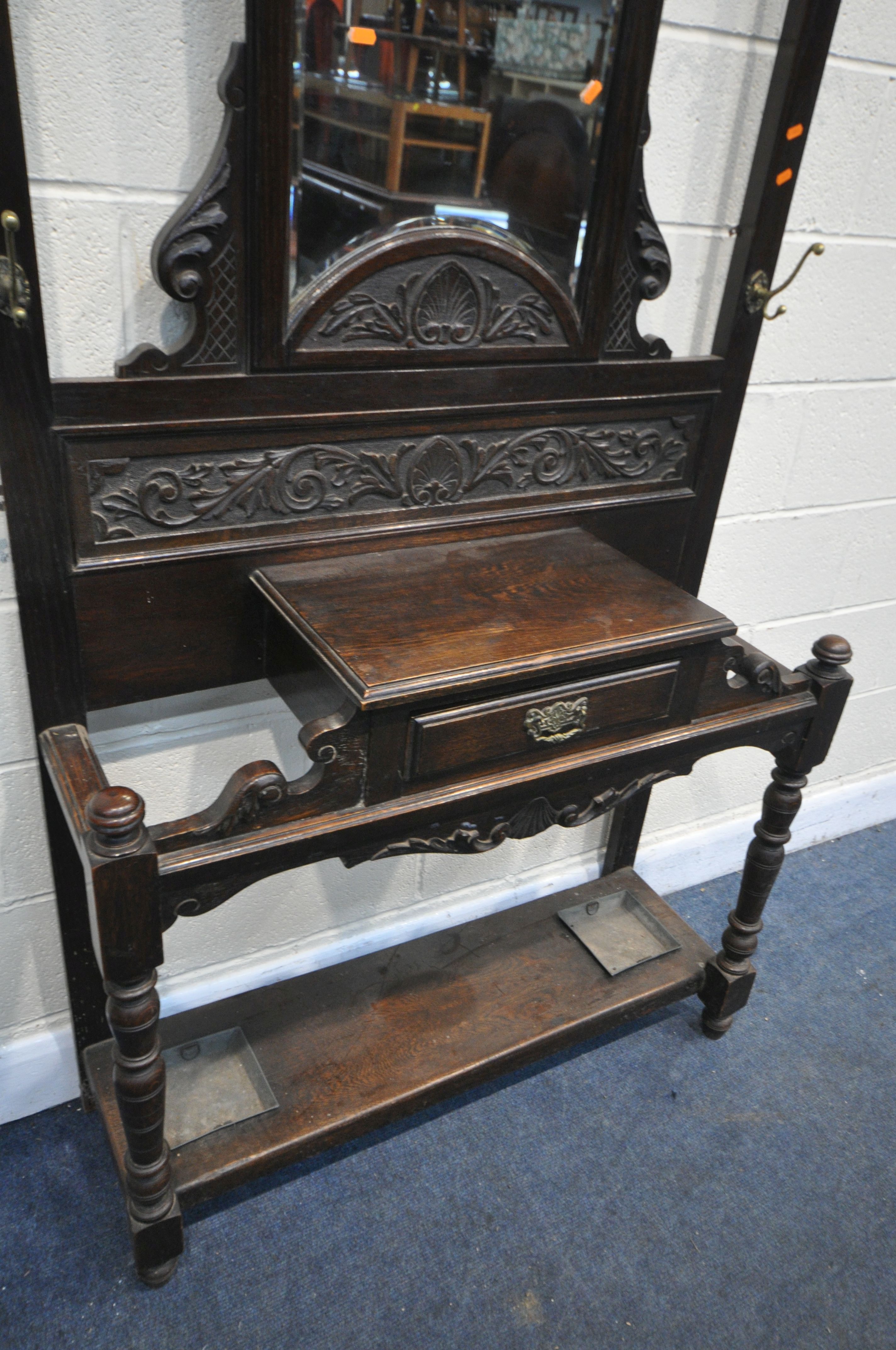 A LATE 19TH CENTURY CARVED OAK HALL STAND, with six brass coat hooks, central shaped bevelled edge - Image 3 of 3