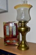 A CHINESE JEWELLERY BOX AND A BRASS BODIED OIL LAMP, the wooden jewellery box having brass handles