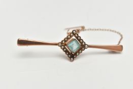 A ROSE METAL, GEM SET BAR BROOCH, tapering polished bar, displaying a square cut pale blue stone