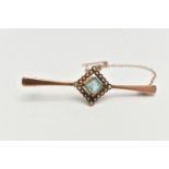 A ROSE METAL, GEM SET BAR BROOCH, tapering polished bar, displaying a square cut pale blue stone