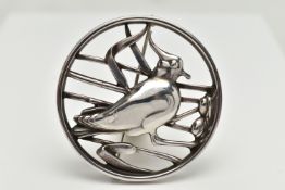 A GEORG JENSEN SILVER BROOCH, of an openwork circular form displaying a bird in a nest within reeds,