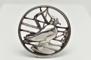 A GEORG JENSEN SILVER BROOCH, of an openwork circular form displaying a bird in a nest within reeds,