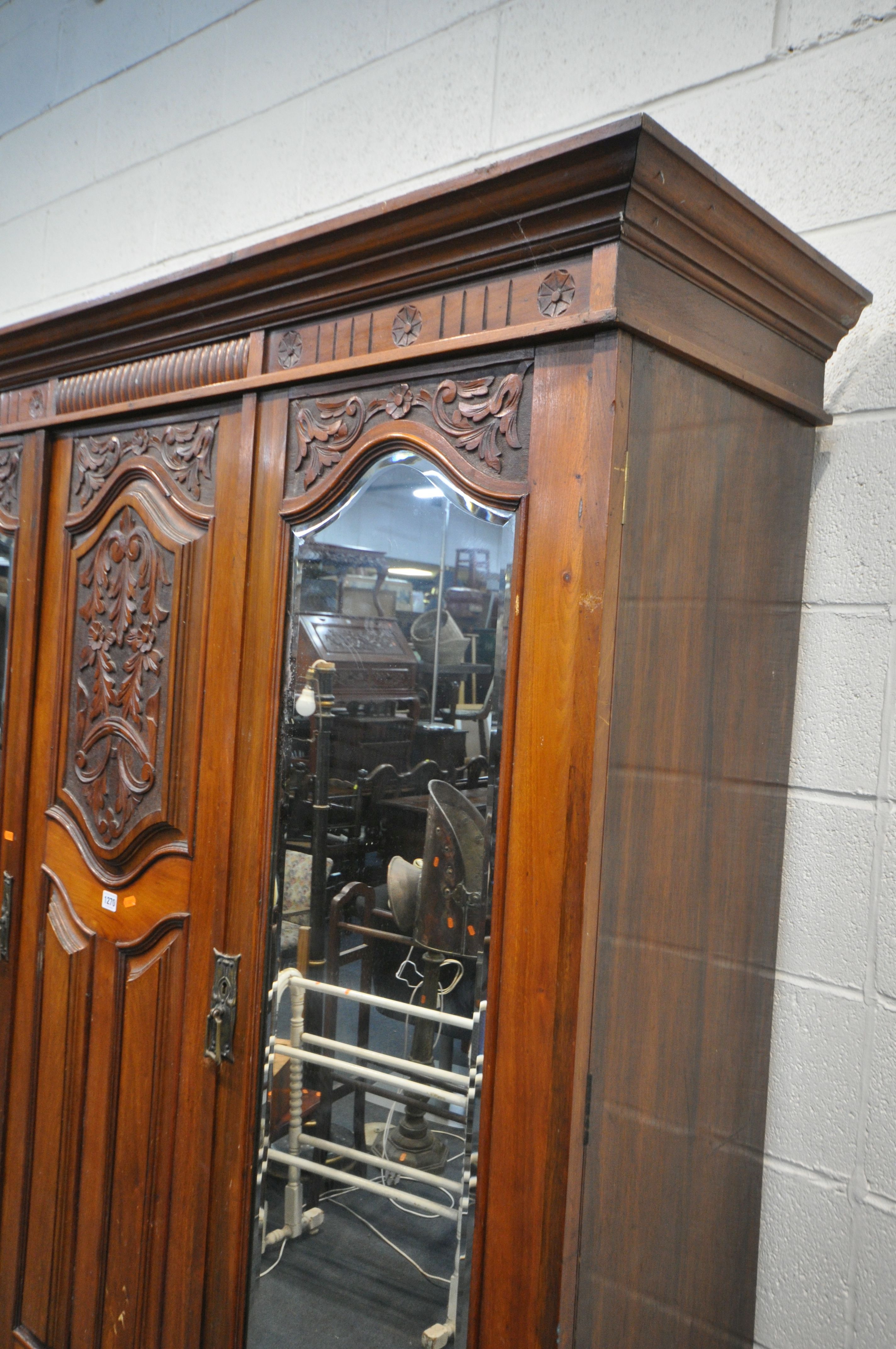 AN EDWARDIAN WALNUT WARDROBE, with two bevelled mirror doors that's flanking a fixed panel, over - Image 3 of 5