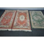 TWO PINK CHINESE WOOLLEN RUGS, 160cm x 91cm, and a green Chinese rug (condition:-all good condition)