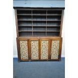 A LARGE VICTORIAN WALNUT BOOKCASE, the top with an open section with five shelves united by