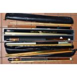 A BOX OF SNOOKER CUES AND CASES, comprising a BCE Jimmy White cue - tip missing, BCE Sly Shaft