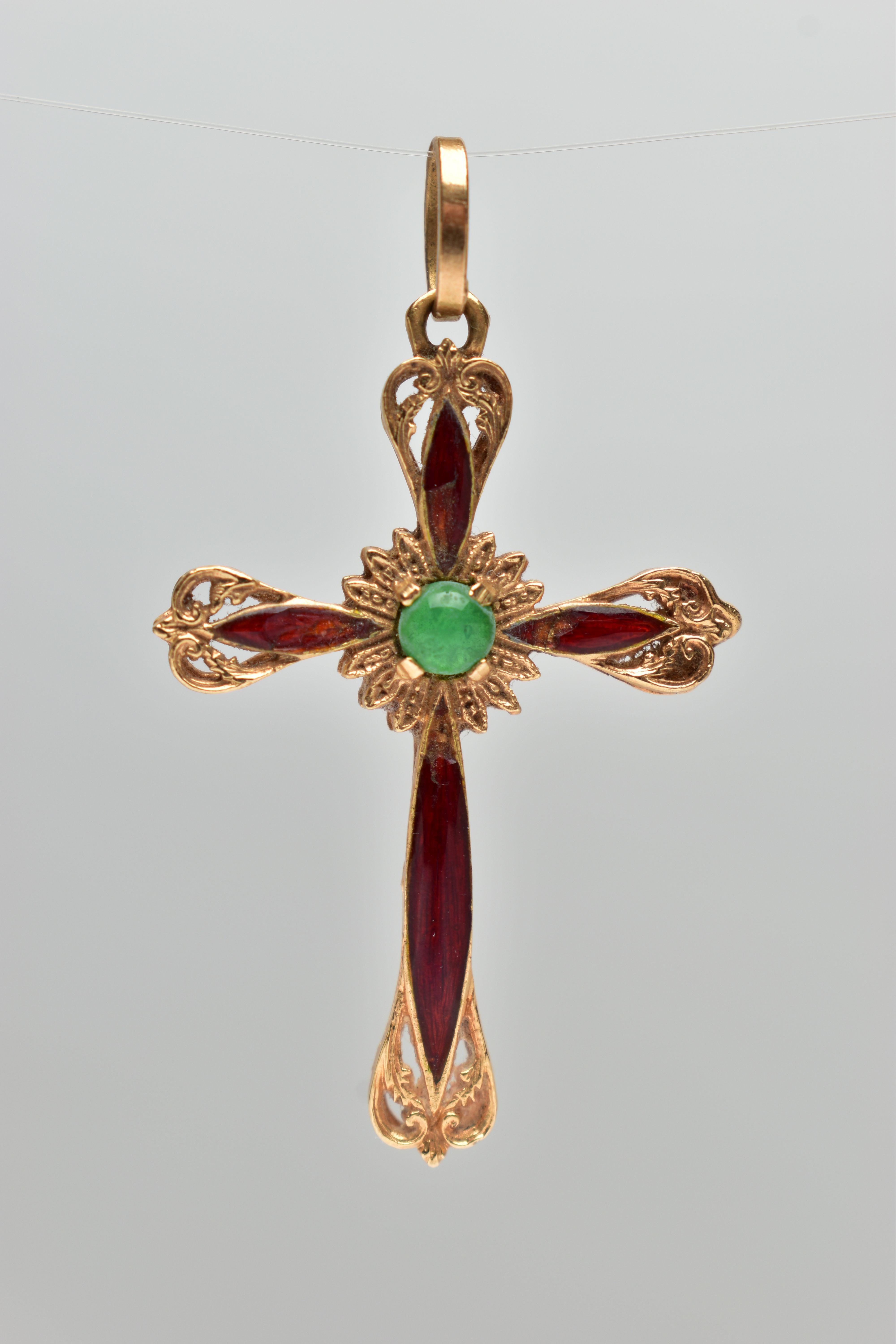 A YELLOW METAL ENAMEL CROSS PENDANT, scroll detailed cross with red enamel, to the centre is a