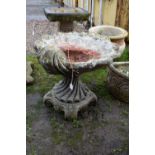 A MODERN COMPOSITE BIRD BATH in the form of an Oyster shell bowl on a linen swag base with four