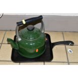 A CAST IRON GRIDDLE PAN AND LE CREUSET KETTLE, a dark green 2.1 litre Le Creuset kettle suitable for