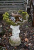 A WEATHERED COMPOSITE SHELL SHAPED BIRD BATH, on a three shaped support, diameter 54cm x 74cm