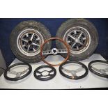 A PAIR OF MGB WHEELS along with five steering wheels comprising three leather and foam, a wood