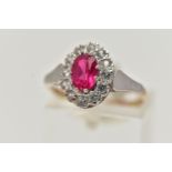 A 9CT GOLD CLUSTER RING, of an oval form, centring on an oval cut synthetic ruby, in a surround of