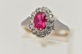 A 9CT GOLD CLUSTER RING, of an oval form, centring on an oval cut synthetic ruby, in a surround of