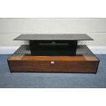 A BLACK TEMPERED GLASS TV STAND, with a fall front door, width 110cm x depth 53cm x height 39cm,