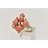 A 9CT GOLD CORAL RING, four marquise cabochon coral stones set as a cluster in a yellow gold