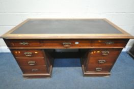 A EARLY 20TH CENTURY WALNUT PEDESTAL DESK, with a leatherette writing surface, nine drawers, on a