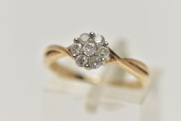 A 9CT GOLD DIAMOND CLUSTER RING, of a flower shape, set with seven round brilliant cut diamonds,