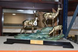 A LARGE FRENCH ART DECO FIGURAL GROUP, of three deer on a hillside, cold painted metal on a black