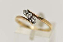 A YELLOW METAL THREE STONE DIAMOND RING, set with three old cut diamonds, estimated total diamond