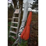 A HARTMAN ORANGE WIND OUT PARASOL, along with a garden clothes airer and an aluminium step ladder (