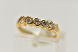 A YELLOW METAL FIVE STONE DIAMOND RING, five round brilliant cut diamonds, estimated total diamond