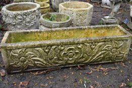A WEATHERED COMPOSITE RECTANGULAR PLANTER, with a floral design, length 98cm x depth 25cm x height