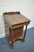 A REGENCY MAHOGANY DAVENPORT, the sloped top with a leather writing surface, enclosing a fitted