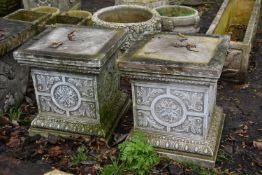 A PAIR OF WEATHERED COMPOSITE GARDEN PLINTHS, with a foliate design, 38cm squared x height 42cm