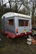 A SMALL SINGLE AXLE CARAVAN, in grey and red, length 280cm x depth 190cm x height 226cm (in need