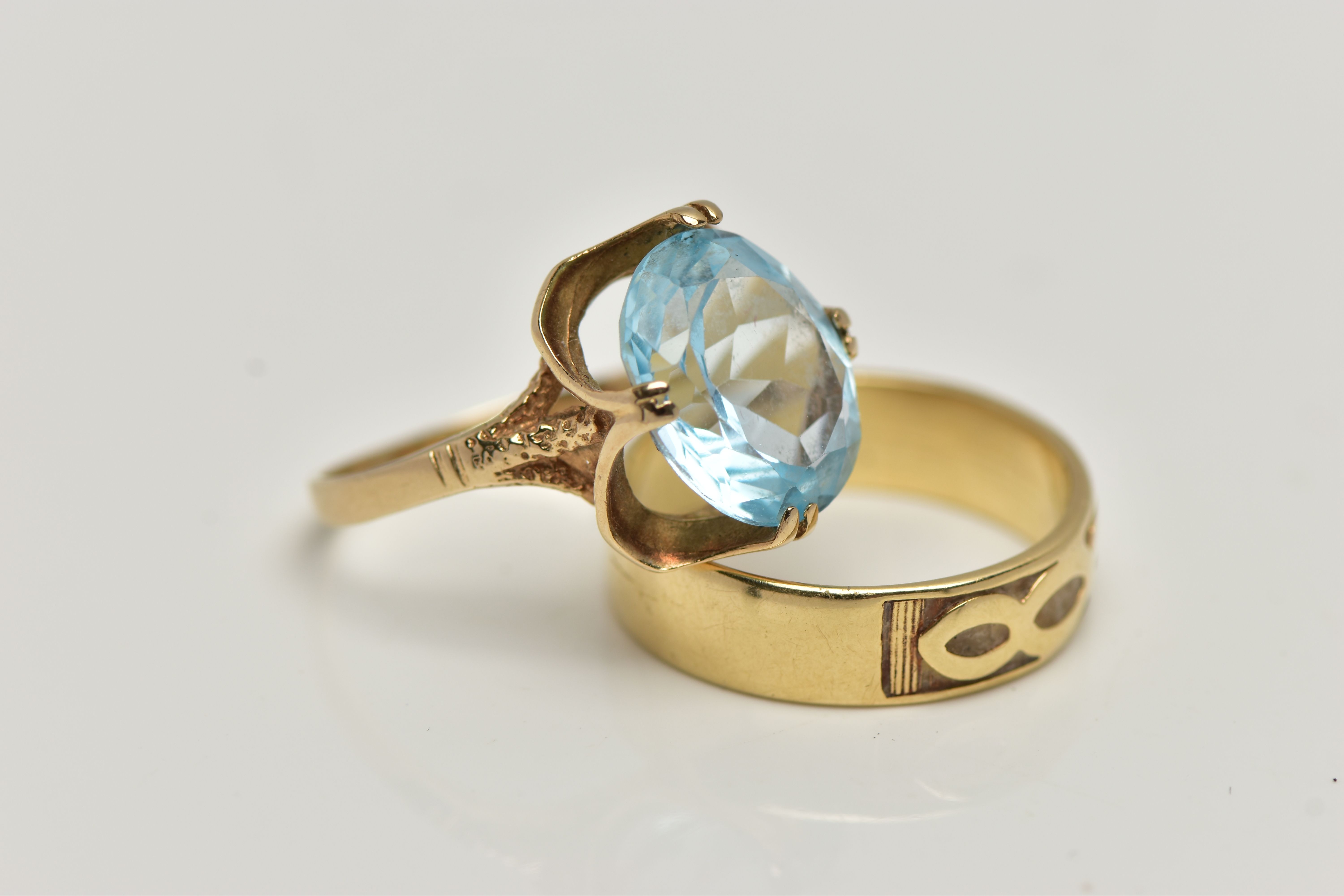 TWO 9CT GOLD RINGS, the first designed with a double four claw set, oval cut light blue topaz, in an - Image 2 of 4