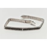 A 9CT GOLD DIAMOND BRACELET, a white gold line bracelet comprised of eight panels, detailed with a