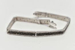 A 9CT GOLD DIAMOND BRACELET, a white gold line bracelet comprised of eight panels, detailed with a
