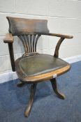 A EARLY TO MID 20TH CENTURY BEECH SWIVEL CHAIR, with a green leather seat (condition:-worn finish)