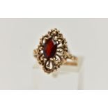 A 9CT GOLD GARNET RING, of an openwork marquise outline, set to the centre with a marquise cut