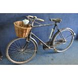 A VINTAGE RALEIGH BICYCLE, needs some attention, with front wicker basket and headlamp and a vintage