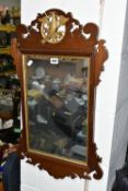 A FRET CUT EDWARDIAN STYLE WALL MIRROR, with a central carved Hoho bird and gilt framed mirror,