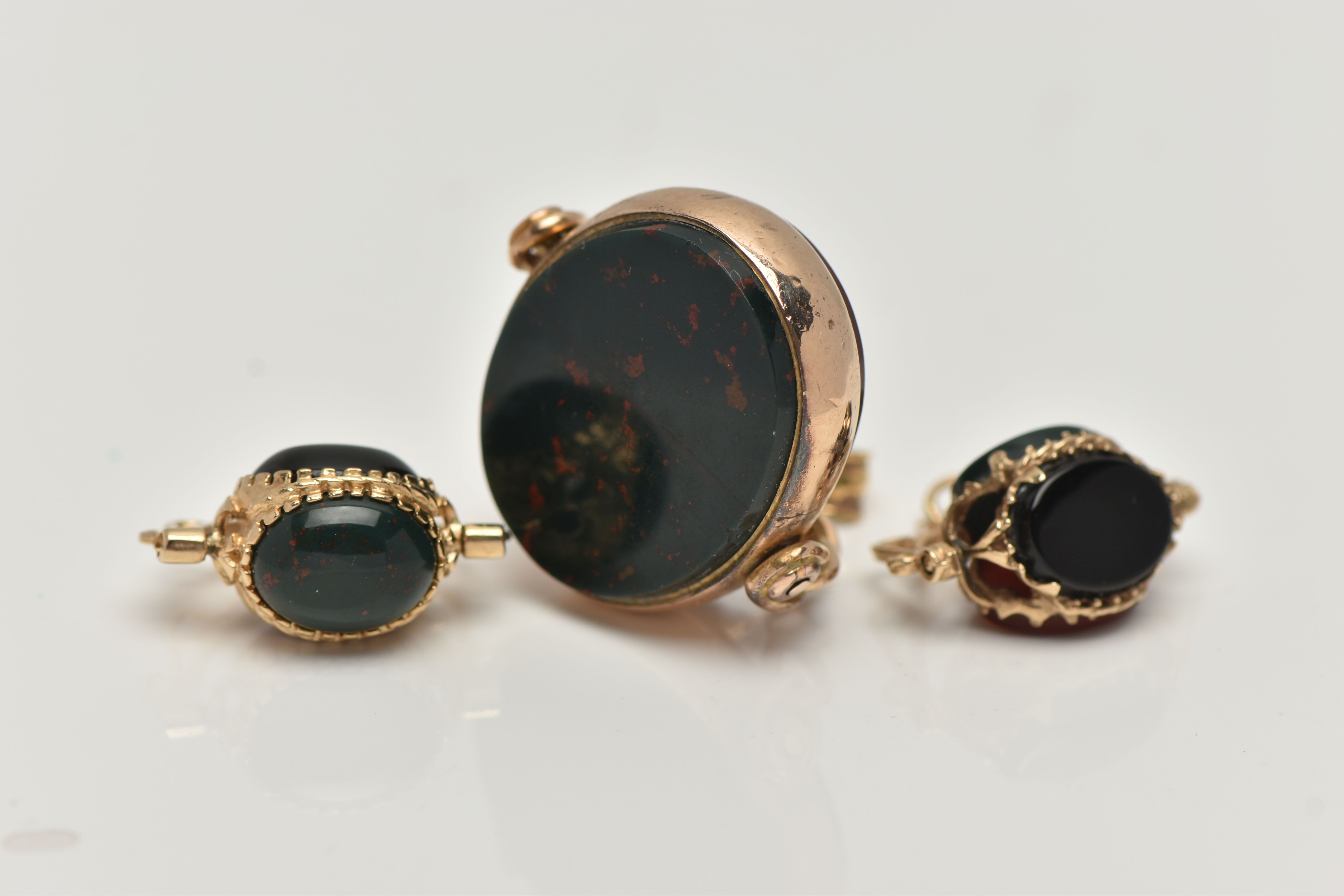 THREE SWIVEL PENDANTS, the first an oval swivel pendant set with a carnelian and a bloodstone inlay, - Image 2 of 4