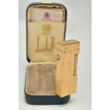 A CASED DUNHILL ROLLAGAS LIGHTER, of gold plated, engine turned design, stamped Made In Switzerland,