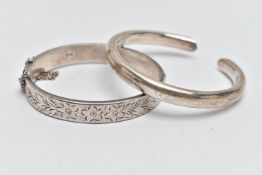 A SILVER HINGED BANGLE AND WHITE METAL CUFF BANGLE, a silver bangle with an etched floral design,