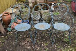 A SET OF THREE METAL GARDEN CHAIRS with circular seats and scrolled back and legs (3)
