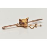 A YELLOW METAL FOX HEAD BROOCH, polished rose metal bar set with a textured fox head with ruby eyes,