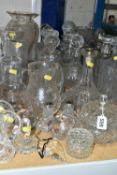 A COLLECTION OF CUT CRYSTAL, comprising twelve assorted decanters, silver 'Gin' label decorated with