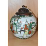 A CHINESE FAMILLE VERTE GINGER JAR, with pierced and carved wooden cover, decorated with a scene