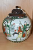 A CHINESE FAMILLE VERTE GINGER JAR, with pierced and carved wooden cover, decorated with a scene
